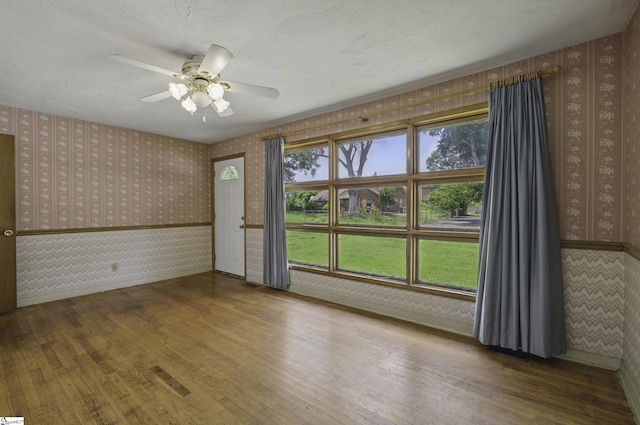 367 Janulis St, Spartanburg, SC 29301 - unfurnished room with wallpapered walls, wood finished floors, ceiling fan, and baseboards