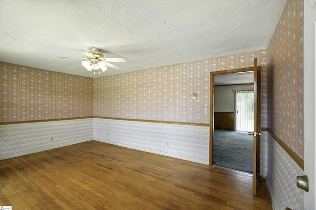 367 Janulis St, Spartanburg, SC 29301 - empty room with wallpapered walls, wood finished floors, ceiling fan, and baseboards