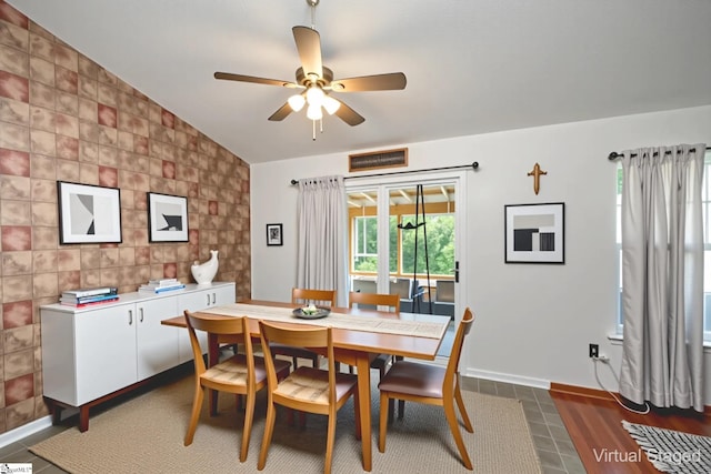10 Sunset Mountain Ct, Travelers Rest, SC 29690 - dining room with plenty of natural light, a ceiling fan, vaulted ceiling, tile walls, and baseboards
