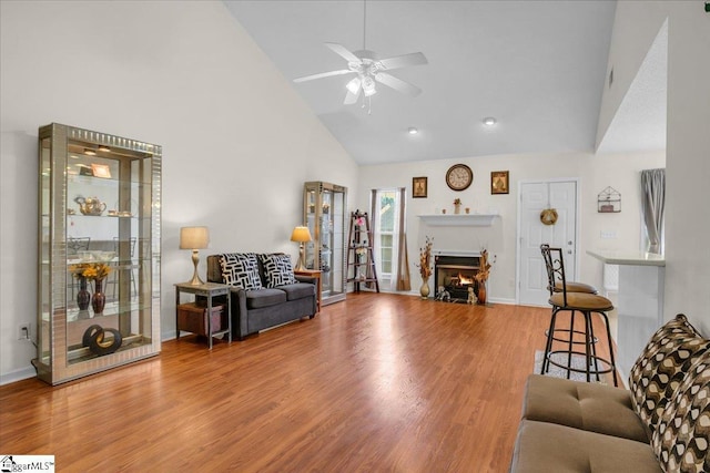 104 Pin Oak Dr, Greenwood, SC 29649 - living area featuring ceiling fan, high vaulted ceiling, wood finished floors, a fireplace with flush hearth, and baseboards
