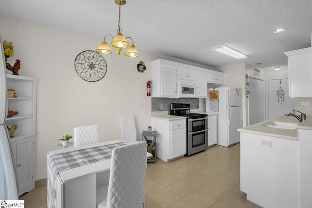 104 Pin Oak Dr, Greenwood, SC 29649 - kitchen featuring white appliances, a sink, light countertops, white cabinets, and backsplash