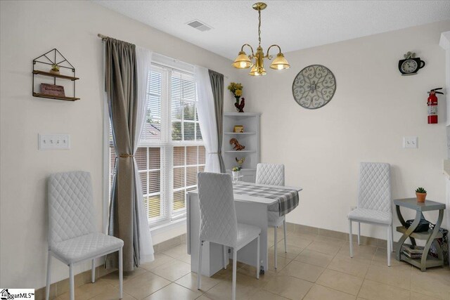 104 Pin Oak Dr, Greenwood, SC 29649 - dining area featuring a chandelier, baseboards, light tile patterned flooring, and a textured ceiling