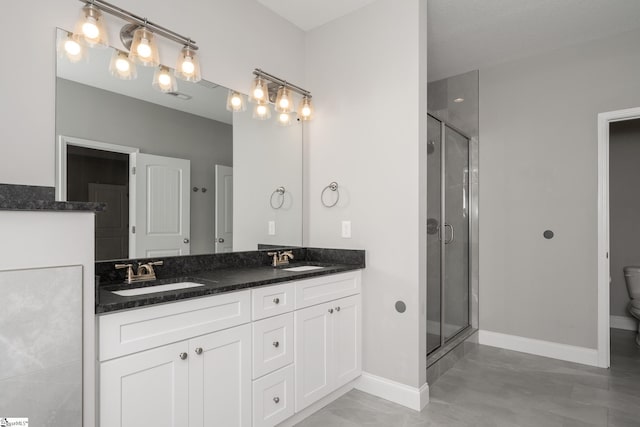 100 Holly Dr, Duncan, SC 29334 - bathroom featuring double vanity, a shower stall, toilet, and baseboards