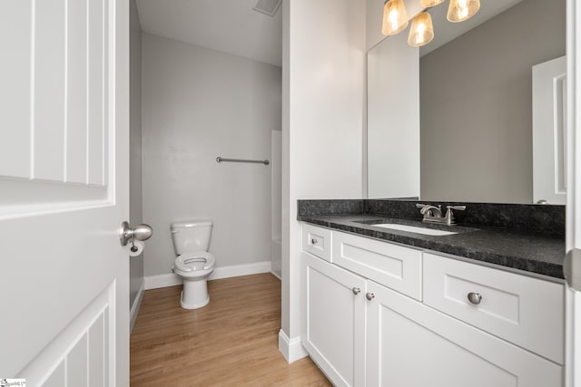 100 Holly Dr, Duncan, SC 29334 - bathroom featuring vanity, toilet, baseboards, wood finished floors, and a chandelier