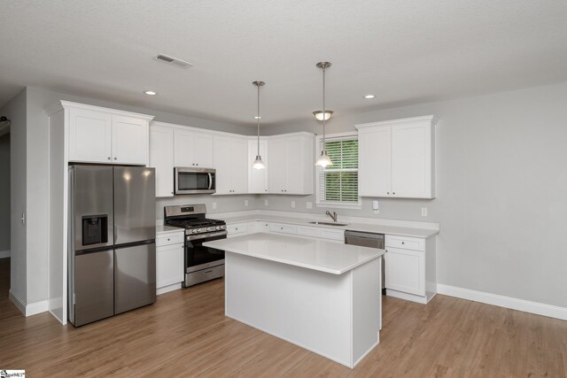100 Holly Dr, Duncan, SC 29334 - kitchen featuring stainless steel appliances, baseboards, light countertops, light wood-style flooring, and recessed lighting