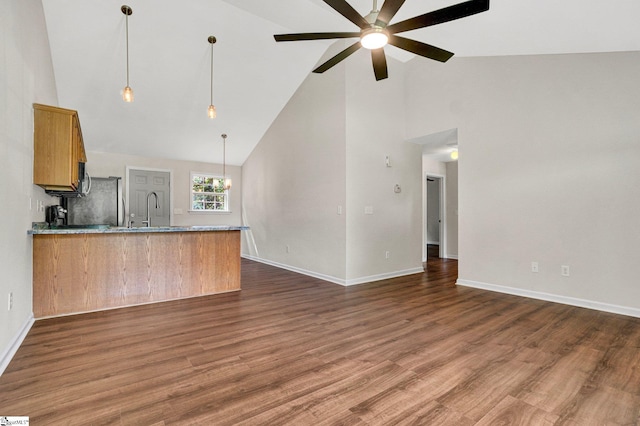114 Tamelia Ct, Greer, SC 29650 - kitchen with high vaulted ceiling, a peninsula, ceiling fan, brown cabinets, and baseboards