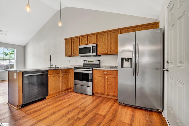 114 Tamelia Ct, Greer, SC 29650 - kitchen with stainless steel appliances, brown cabinetry, light wood finished floors, and high vaulted ceiling