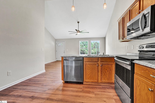 114 Tamelia Ct, Greer, SC 29650 - kitchen featuring stainless steel appliances, lofted ceiling, brown cabinets, ceiling fan, and a peninsula