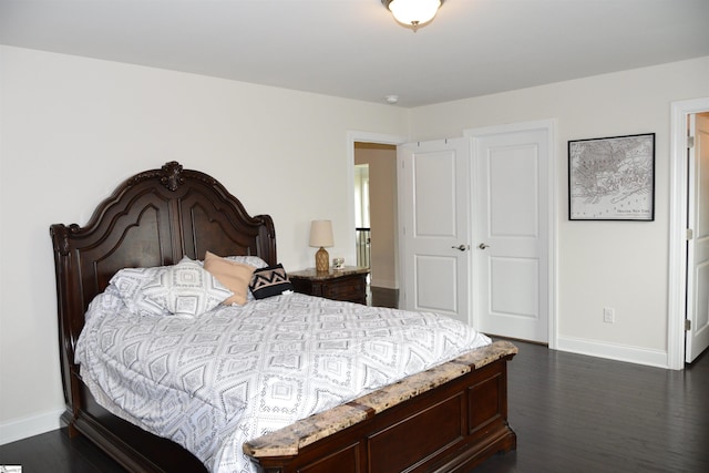 127 Riverland Woods Ct, Simpsonville, SC 29681 - bedroom with baseboards, dark wood-type flooring, and a closet
