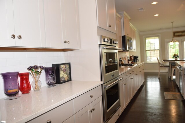 127 Riverland Woods Ct, Simpsonville, SC 29681 - kitchen with stainless steel appliances, crown molding, recessed lighting, backsplash, and baseboards