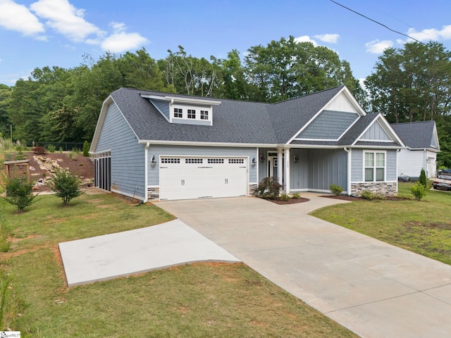 220 Plantation Rd, Greenville, SC 29605 - craftsman-style house with board and batten siding, stone siding, a front lawn, a garage, and concrete driveway