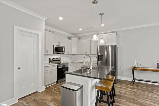 220 Plantation Rd, Greenville, SC 29605 - kitchen featuring appliances with stainless steel finishes, a sink, crown molding, dark wood finished floors, and decorative backsplash