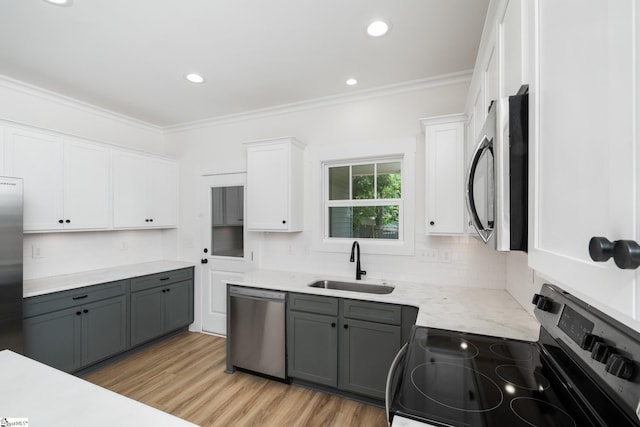 101 Duke St, Greenville, SC 29609 - kitchen with stainless steel appliances, a sink, gray cabinetry, white cabinetry, and ornamental molding