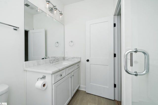 101 Duke St, Greenville, SC 29609 - full bathroom with vanity, wood finished floors, and toilet