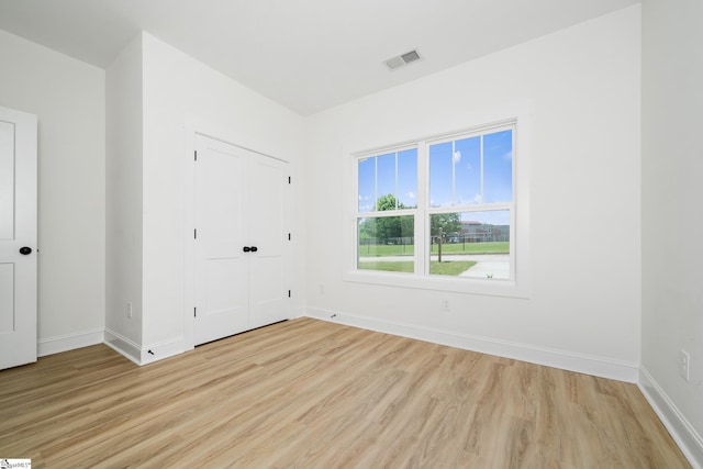 101 Duke St, Greenville, SC 29609 - unfurnished bedroom featuring light wood-style floors, baseboards, and a closet