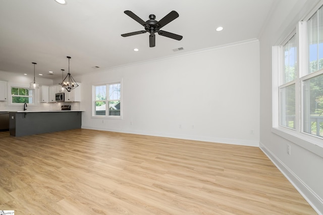 101 Duke St, Greenville, SC 29609 - unfurnished living room with crown molding, healthy amount of natural light, recessed lighting, light wood-style flooring, and baseboards