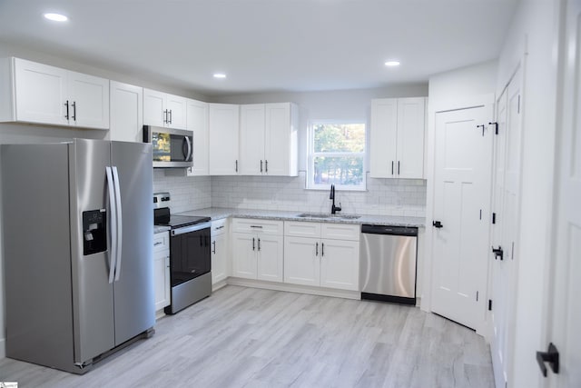 3834 Maid Marion Ln, Spartanburg, SC 29302 - kitchen featuring stainless steel appliances, a sink, white cabinets, light stone counters, and recessed lighting