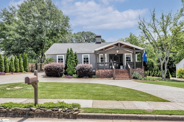 15 High Hill St, Greenville, SC 29605 - view of front of house with covered porch, concrete driveway, and a chimney