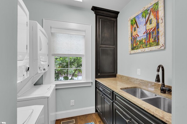 15 High Hill St, Greenville, SC 29605 - washroom with stacked washer and clothes dryer, cabinet space, wood finished floors, and baseboards