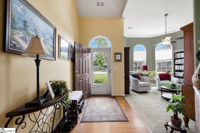 101 Roberts Hill Dr, Taylors, SC 29687 - foyer entrance with a towering ceiling, a ceiling fan, light wood-style floors, baseboards, and crown molding