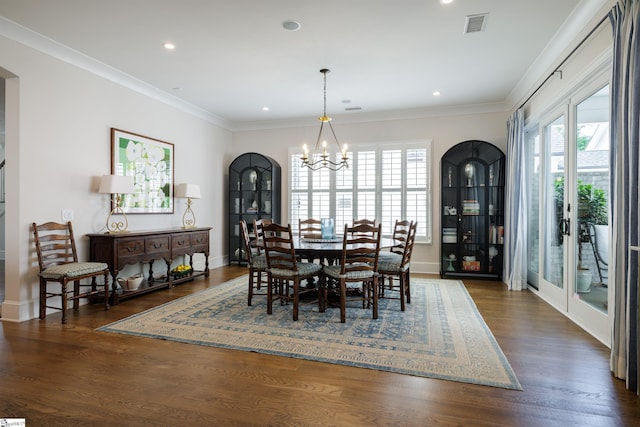 36 Southland Ave, Greenville, SC 29601 - dining room with a chandelier, plenty of natural light, dark wood-style flooring, arched walkways, and ornamental molding