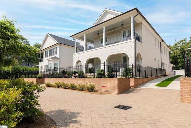 36 Southland Ave, Greenville, SC 29601 - view of front of property with a balcony, a fenced front yard, and brick siding