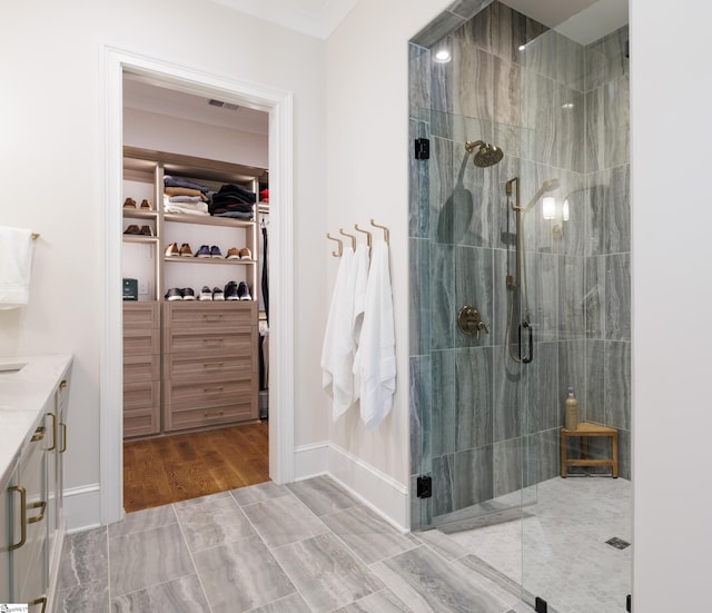 36 Southland Ave, Greenville, SC 29601 - full bathroom featuring a shower stall, a walk in closet, vanity, and wood finished floors