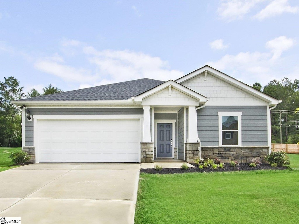 607 Tilson Rd, Piedmont, SC 29673 - craftsman-style house with stone siding, concrete driveway, a garage, and a front lawn