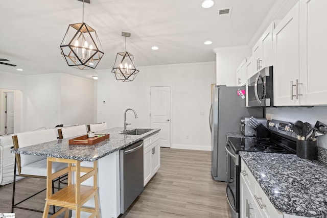 381 Butler Rd, Lyman, SC 29365 - kitchen with stainless steel appliances, a sink, ornamental molding, white cabinetry, and a center island with sink