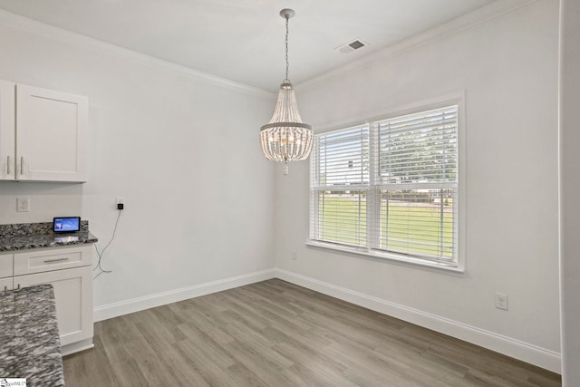 381 Butler Rd, Lyman, SC 29365 - unfurnished dining area with light wood finished floors, ornamental molding, a chandelier, and baseboards