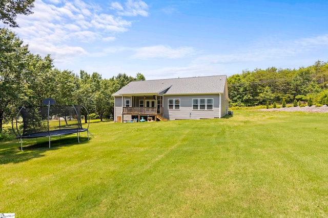 381 Butler Rd, Lyman, SC 29365 - back of property with a trampoline, a deck, a lawn, and stairs