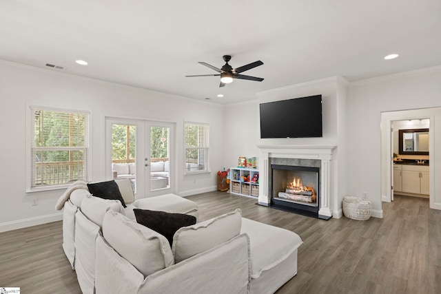 381 Butler Rd, Lyman, SC 29365 - living room with a ceiling fan, crown molding, baseboards, wood finished floors, and a warm lit fireplace