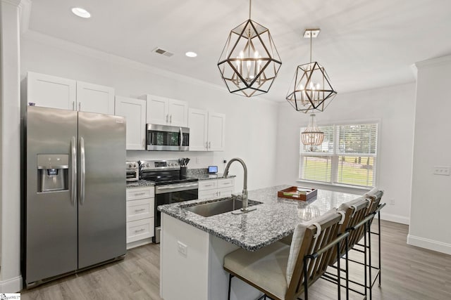 381 Butler Rd, Lyman, SC 29365 - kitchen with stainless steel appliances, a sink, a chandelier, ornamental molding, and white cabinetry