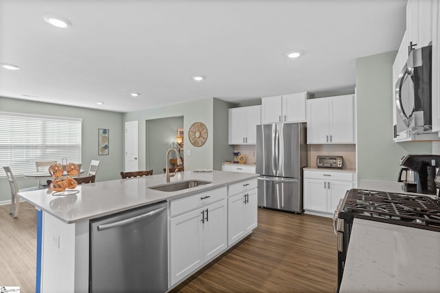 224 Anna Gray Cir, Easley, SC 29640 - kitchen with appliances with stainless steel finishes, a sink, a kitchen island with sink, dark wood-style flooring, and white cabinets