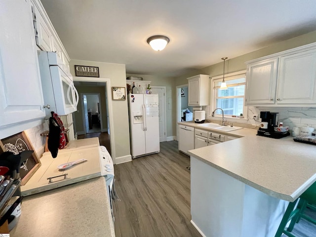 206 Caldwell St, Clinton, SC 29325 - kitchen featuring white appliances, a sink, a peninsula, decorative backsplash, and white cabinetry