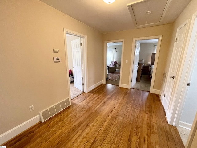 206 Caldwell St, Clinton, SC 29325 - hallway with attic access, light wood-type flooring, and baseboards