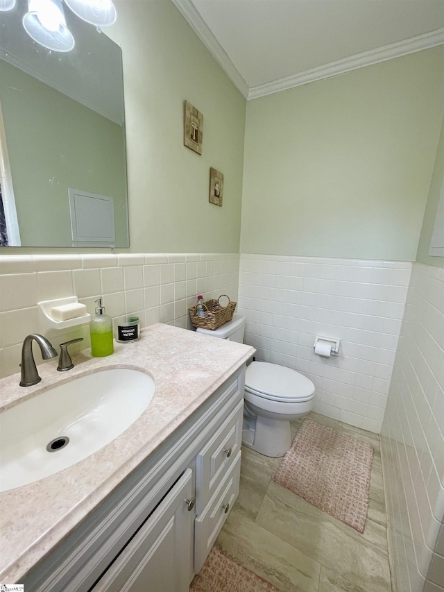 206 Caldwell St, Clinton, SC 29325 - bathroom with tile walls, toilet, ornamental molding, vanity, and wainscoting