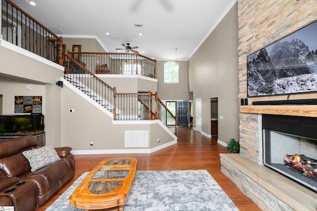 112 Woodstone Dr, Easley, SC 29642 - living room with crown molding, stairway, ceiling fan, a fireplace, and wood finished floors