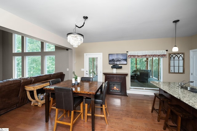 112 Woodstone Dr, Easley, SC 29642 - dining area featuring a chandelier, a glass covered fireplace, and dark wood-style flooring