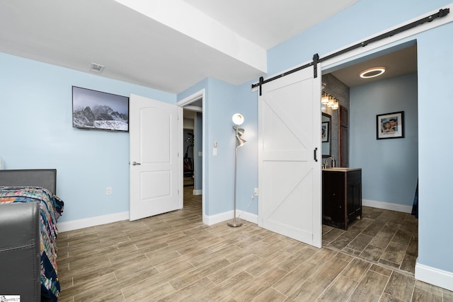112 Woodstone Dr, Easley, SC 29642 - home office with a barn door, baseboards, light wood-style floors, and a sink