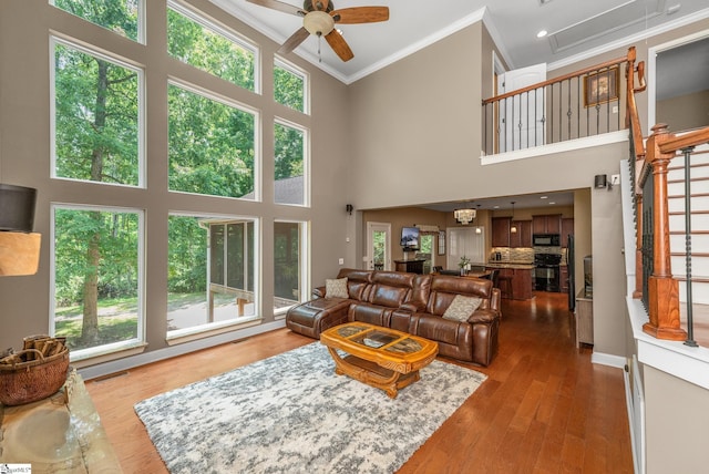 112 Woodstone Dr, Easley, SC 29642 - living room featuring crown molding, a ceiling fan, a high ceiling, plenty of natural light, and wood finished floors