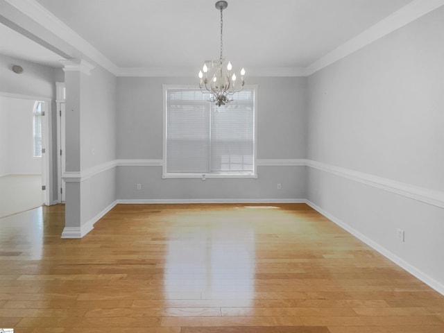 134 Lauren Wood Cir, Taylors, SC 29687 - unfurnished room with light wood-style floors, a chandelier, baseboards, and crown molding