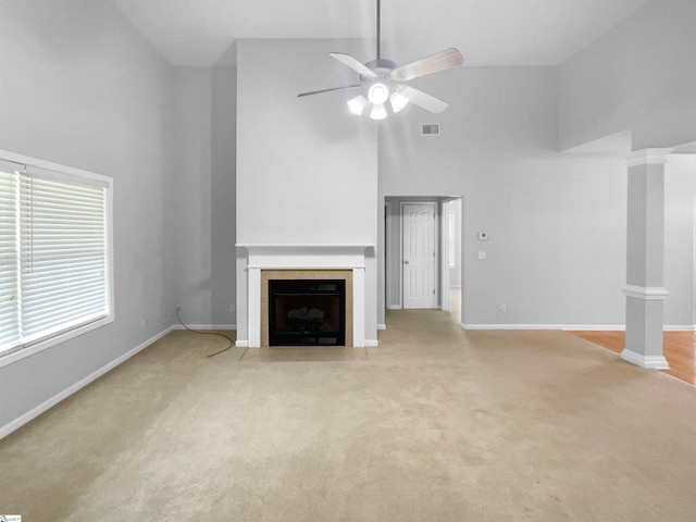 134 Lauren Wood Cir, Taylors, SC 29687 - unfurnished living room with high vaulted ceiling, a fireplace with flush hearth, ceiling fan, light colored carpet, and baseboards