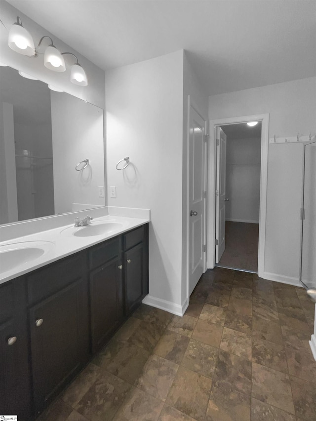 253 Golden Bear Walk, Duncan, SC 29334 - bathroom featuring double vanity, baseboards, and stone finish floors