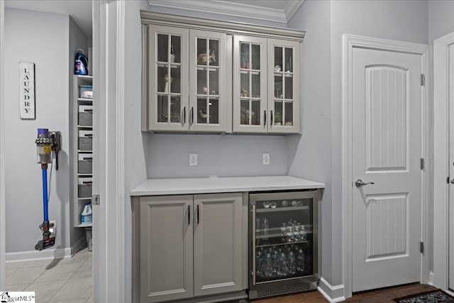 79 Modesto Ln, Simpsonville, SC 29681 - bar featuring beverage cooler, crown molding, and baseboards