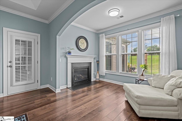 79 Modesto Ln, Simpsonville, SC 29681 - living area featuring dark wood finished floors, ornamental molding, baseboards, and a glass covered fireplace