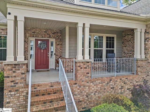 79 Modesto Ln, Simpsonville, SC 29681 - view of exterior entry featuring covered porch, a shingled roof, and brick siding
