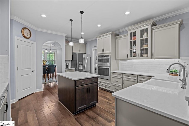 79 Modesto Ln, Simpsonville, SC 29681 - kitchen with appliances with stainless steel finishes, a sink, crown molding, backsplash, and glass insert cabinets