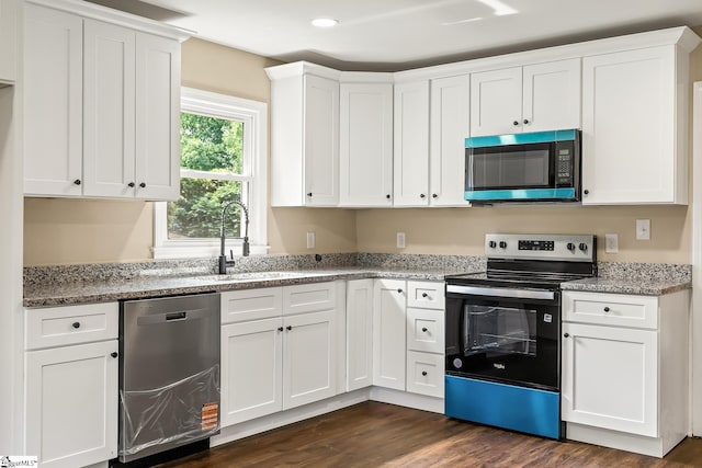 3401 Comanche St, Anderson, SC 29626 - kitchen with appliances with stainless steel finishes, white cabinetry, dark wood-type flooring, light stone counters, and recessed lighting