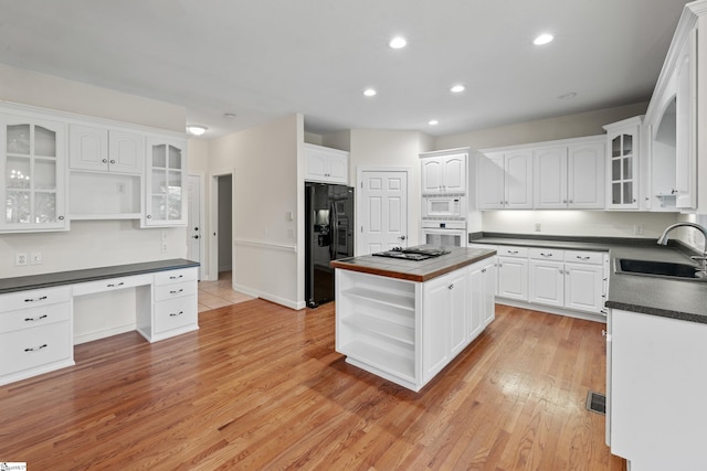 118 Pinnacle Pointe Dr, Seneca, SC 29672 - kitchen featuring open shelves, white appliances, dark countertops, white cabinetry, and a kitchen island